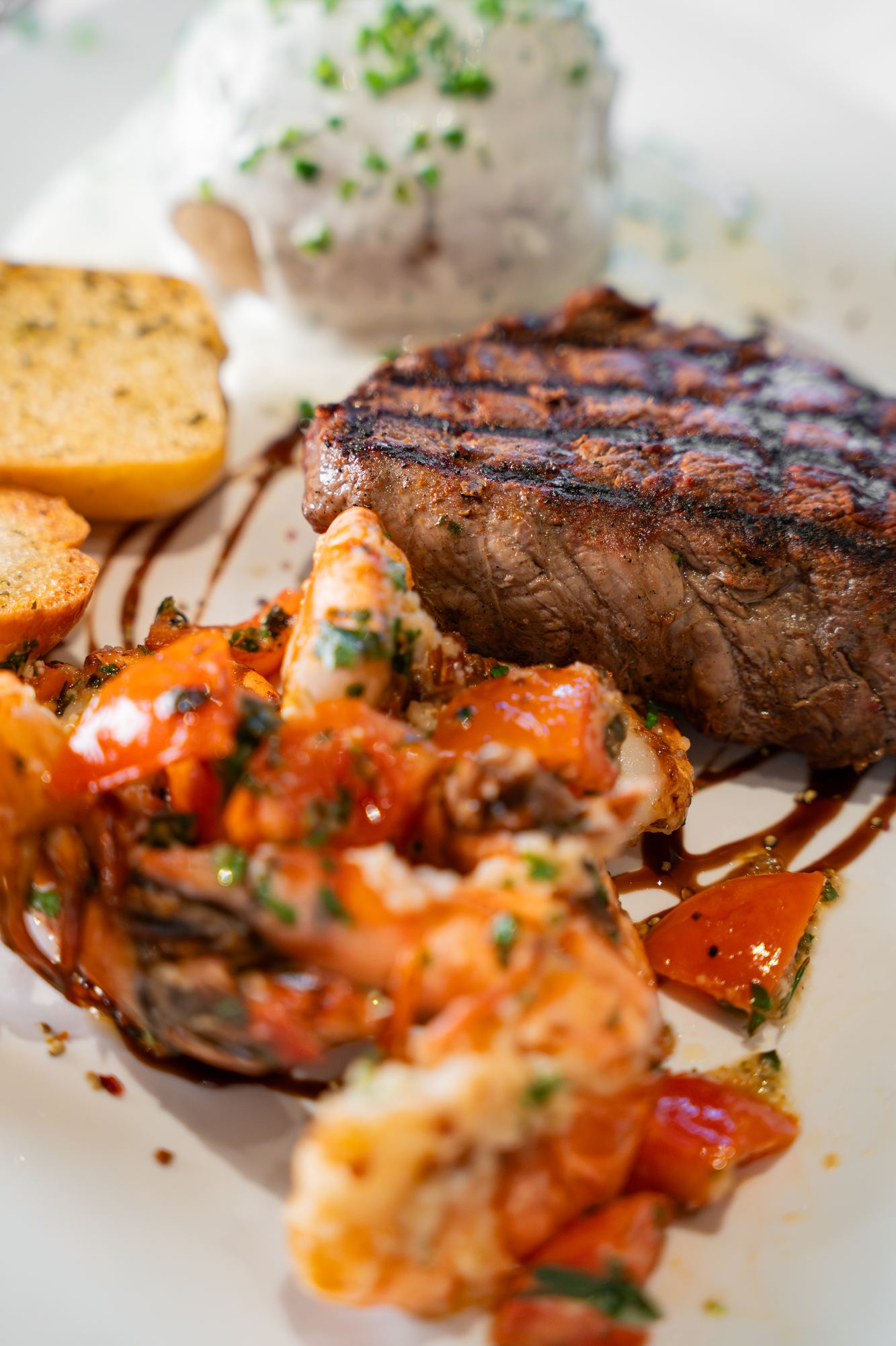 Steak with prawns and potatoes